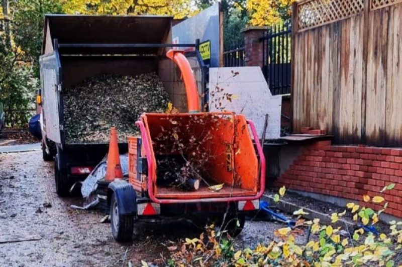 Wood chipper and truck clearing green waste from a garden